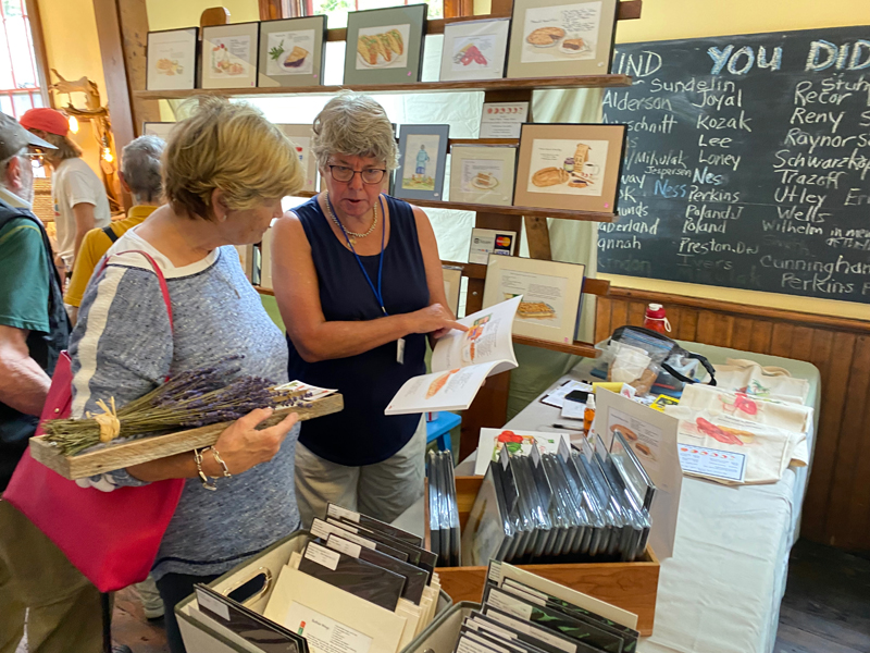 Shoppers browse at a previous arts fair in the Washington Schoolhouse. (Photo courtesy Round Pond Schoolhouse Association)