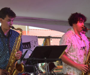 Lincoln Academy Class of 2023 graduates Liam Card (left) and Cooper Swartzentruber perform with the 5 O'clock Combo at the 2023 Linaca Festival on Friday, Aug. 4 at Schooner Landing Restaurant and Marina in Damariscotta. (Dylan Burmeister photo)