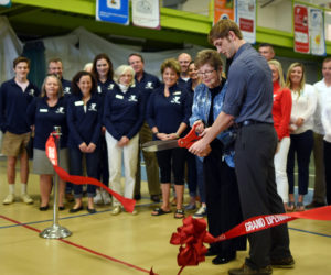 Janice Sprague and her grandson, Nate Masters, cut the ribbon during the grand reopening of the CLC YMCA in Damariscotta on April 29, 2018. Sprague and her late husband, Neil, founded the recreation center that preceded the CLC YMCA. (LCN file photo)