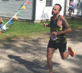 Brett Almasi crosses the finish line at the Westport Island Shore Run 10K Road Race on Sunday, Aug. 20. (Courtesy photo)