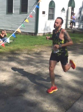 Brett Almasi crosses the finish line at the Westport Island Shore Run 10K Road Race on Sunday, Aug. 20. (Courtesy photo)