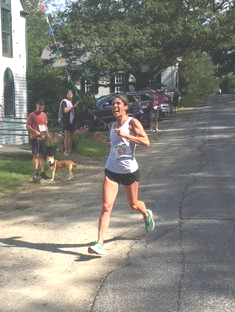 Top female finisher Paige Roberts crosses the finish line at the Westport Island Shore Run 10K Road Race. (Courtesy photo)