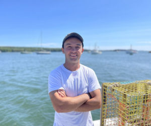 Kyle O'Brien, a fourth generation Bremen lobsterman, stands on the stern of his boat Daylight Till Dark, docked at Broad Cove Marine at the end of the Medomack Road. (Johnathan Riley photo)