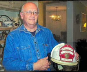 Paul Leeman Jr. holds the white Bristol fire chief helmet. A longtime Bristol firefighter and Bristol's first full-time fire chief, Leeman also has been an instructor of shotokan martial arts, as well as a popular cook at restaurants on the Bristol peninsula like The Anchor Inn and Samoset Restaurant. (Photo courtesy Paul Leeman Jr.)