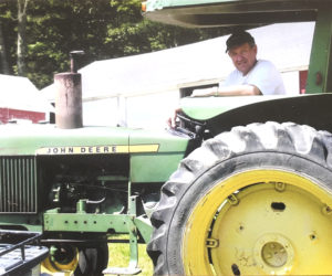 One of Norman C. Hunt's favorite pastimes was being on his tractor as well as being on the Damariscotta Lake with family. (Photo courtesy Robert Hunt)