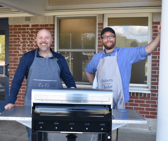 Medomak Middle School Principal Michael Harris (left) and Assistant Principal Zach Snyder prepare for the annual back-to-school hot dog cookout on Thursday, Sept. 14. Both administrators, who are new to MMS, said they were drawn by the district's motto of "inspiring students to achieve lifelong success." (Elizabeth Walztoni photo)