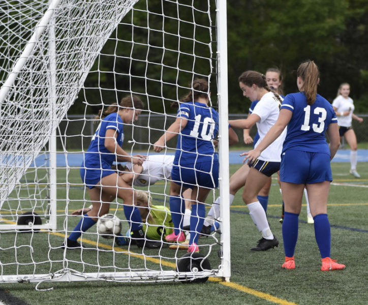 Grace Townsend boots in a rebound in heavy traffic to tie Medomak's game with Morse. (Mic LeBel photo)