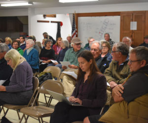 Alna residents fill the firehouse on Thursday, Oct. 19 for a public hearing on a proposed settlement agreement with resident Jeff Spinney (right) in yearslong litigation over his boat ramp into the Sheepscot River. Select board members Steven Graham and Coreysha Stone voted to sign the agreement, which acknowledges Spinney's boat ramp is illegal, allows him to keep and use it, and requires both parties to pay their own attorney costs. (Elizabeth Walztoni photo)