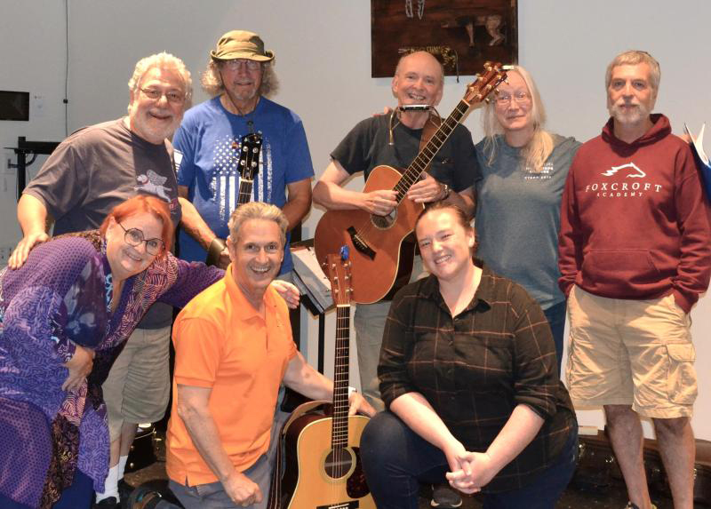 The cast of River CompanyÂ’s production of Â“Woody GuthrieÂ’s American Song.Â” Front row, from left: Ellie Busby, John Monterisi, and Erin Barton. Back row, from left: Nick Azzaretti, Cap'n Frank Bedell, Gary McCue, Ella Ackerman, and Sumner Richards III. (Photo courtesy River Company)