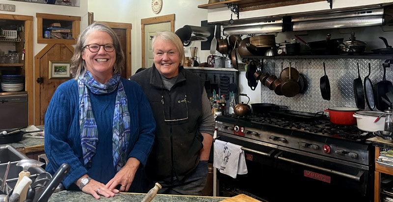 Mary Kate Reny (left) and Marge Kilkelly stand in the kitchen where their cooking show "Nourishing Maine" is filmed. Reny and Kilkelly talk about recipes that feature foods that are close to home and affordable. (Piper Pavelich photo)
