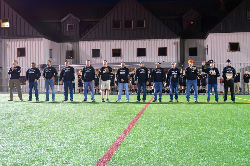 Members of Lincoln Academy's 1987 state champion boys soccer team receive recognition before the school's homecoming game against Medomak Valley on Saturday, Sept. 23. (Photo courtesy Lincoln Academy)