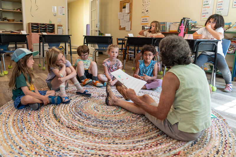 Brightfield first and second grade teacher Lorna Fake reads to her combined class in her new classroom. Brightfield applies a place-based education philosophy, which stresses meaningful engagement with the natural world and local community. (Photo courtesy Kate Hitchings Aholt)