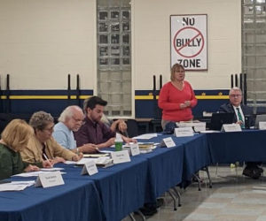 RSU 40 Business Manager Karen Pike addresses the district's board of directors in the Medomak Valley High School cafeteria on Thursday, Oct. 5. Pike presented the board with estimated taxpayer impacts of the $81 million capital improvement bond proposal, which residents in RSU 40 towns will vote on this November. (Molly Rains photo)