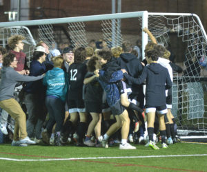 Lincoln Academy fans swarm the boys soccer team after the Eagles defeated Freeport on penalty kicks in a Class C South quarterfinal match on Wednesday, Oct. 25. (Paula Roberts photo)