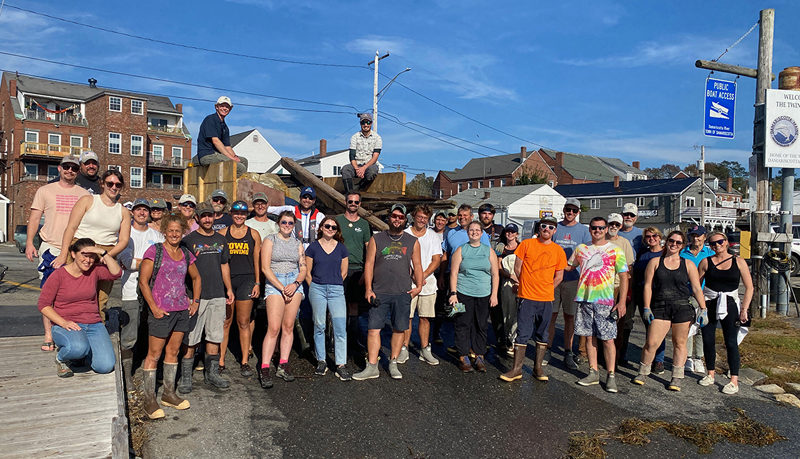 Staff and volunteers from over a dozen local businesses and organizations participating in the annual Damariscotta River cleanup effort stand in front of the truckload of trash they collected from the rivers shoreline on Oct. 3. (Photo courtesy Coastal Rivers Conservation Trust)