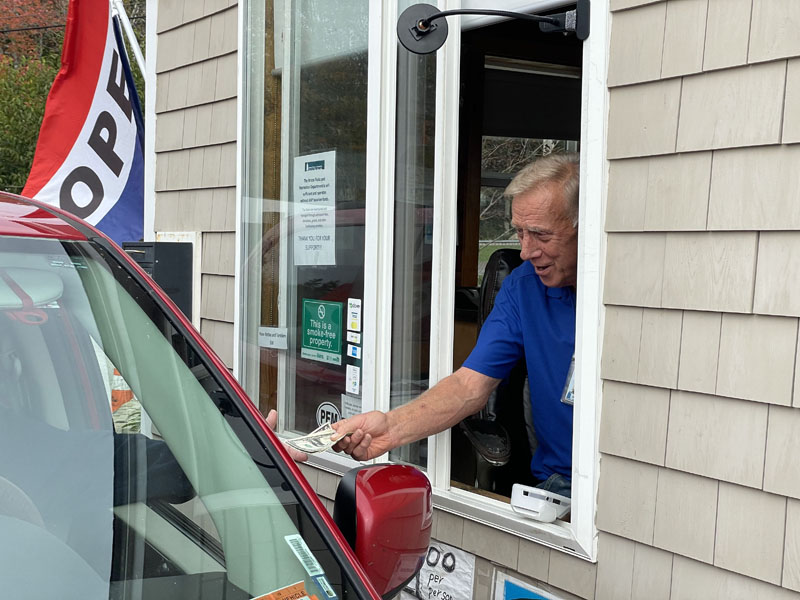 Jim Hazell hands a visitor their change at the entrance to Pemaquid Point Lighthouse Park. Hazell wears many hats for Bristol Parks and Recreation, entrance booth attendant being just one of them. (Johnathan Riley photo)