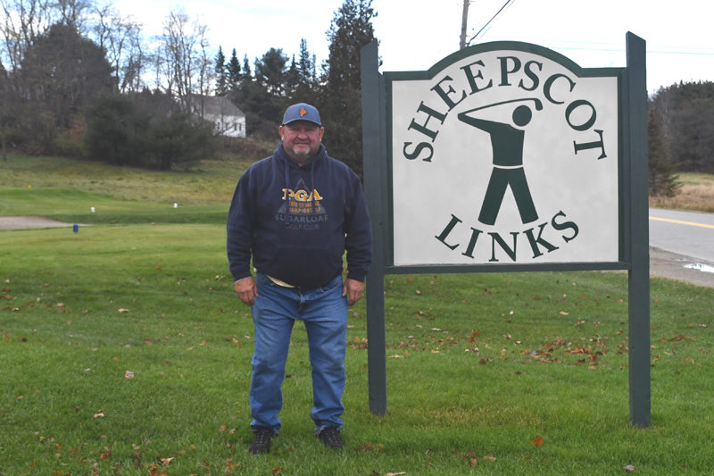 Leon Oliver stands by the entrance of Sheepscot Links, the golf course he co-owns with his wife, Alicia. (Mic LeBel photo)