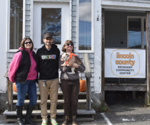 From left: Volunteer Lauren Woodcock, recovery coach Brock Couillard, program coordinator Abigail Boudin, and office dog Goldie stand in front of the Lincoln County Recovery Community Center at 3 Hall St. in Newcastle. "Our hope is to be a space that offers something for truly everyone that's been touched by addiction," Boudin said. (Elizabeth Walztoni photo)