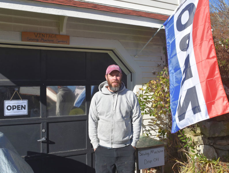 Oliver Butler stands in front of his home workshop in Nobleboro, where he repairs sewing machines of all types and ages. His business is one of only a handful of its kind in the state, and draws customers from Portland to Bangor. (Elizabeth Walztoni photo)