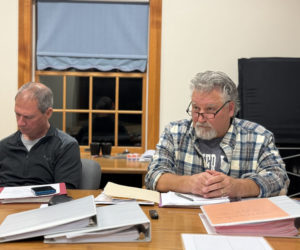 South Bristol Select Board member Robert Clifford (left) reviews documents while Bruce Farrin Jr., the board's chair, listens to an audience member during a meeting on Thursday, Nov. 9. The select board appointed Sandee MacPhee as the interim deputy clerk at the South Bristol town office during the meeting. (Johnathan Riley photo)