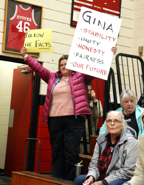 Tanya Robinson, of Waldoboro, holds signs in support of Wiscasset Middle High School Principal Gina Stevens at the special Wiscasset School Committee meeting on Monday, Nov. 13. Robinson is a former WMHS teacher. (Piper Pavelich photo)