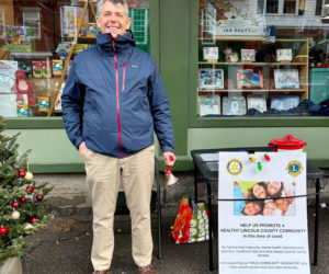 Steven Hufnagel, executive director of Coastal Rivers Conservation Trust, takes a turn ringing the bell in front of Sherman's Maine Coast Book Shop in Damariscotta. (Courtesy photo)