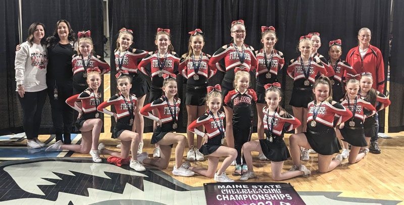 Coach Brie McCarthy (back row, left) with Team Blaze, her state championship-winning team made up of fourth and fifth graders based at Fire House Cheer and Tumble in Topsham. McCarthy has been named an Nfinity Cheer Coach of the Year. (Courtesy photo)