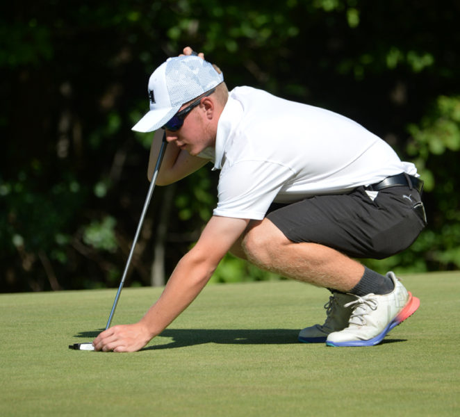 Lincoln Academy golfer Kellen Adickes places his ball on a green at a meet earlier in the season. (Paula Roberts photo, LCN file)