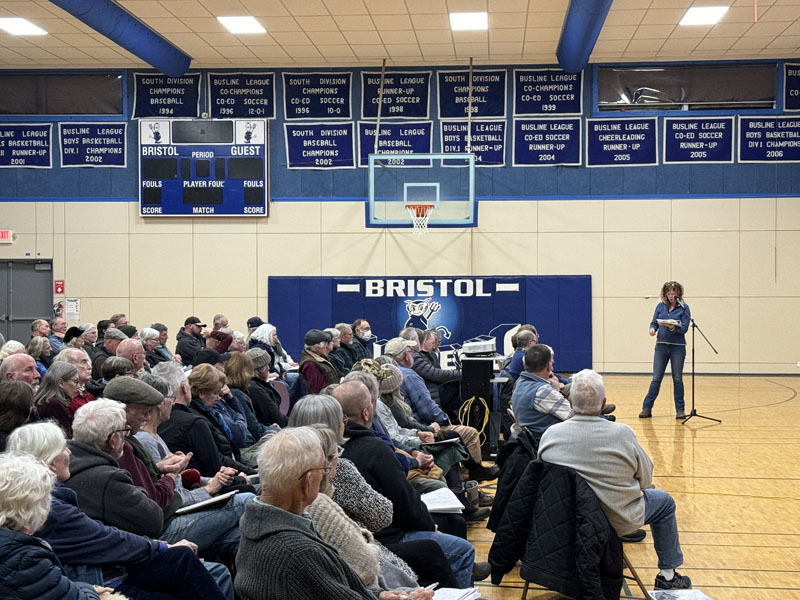 Andrea Perley speaks to attendees at the draft Bristol comprehensive plan public hearing on Thursday, Dec. 7 in the Bristol Consolidated School gymnasium. Perley, a Bristol Planning Board alternate, read comments from concerned Bristol residents who couldnt be in attendance. (Johnathan Riley photo)