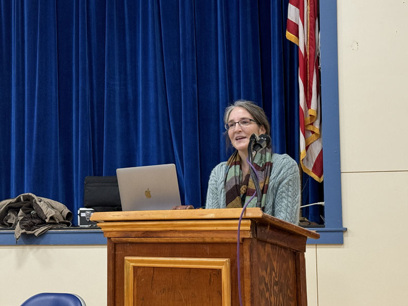 Jess Yates, co-chair of the Bristol Comprehensive Plan Committee, opens the public hearing on Thursday, Dec. 7 at Bristol Consolidated School. Yates presented a slideshow that emphasized the comprehensive plan is a collection of suggestions and is not a mandate. (Johnathan Riley photo)