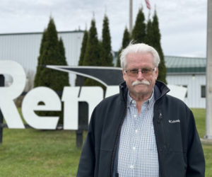John Reny, owner of Renys department stores, stands in front of the Renys warehouse on Route 1 in Newcastle on Friday, Nov. 16. When Reny isnt tending to his executive role with his namesakes store, hes playing music and working in his garden. (Johnathan Riley photo)