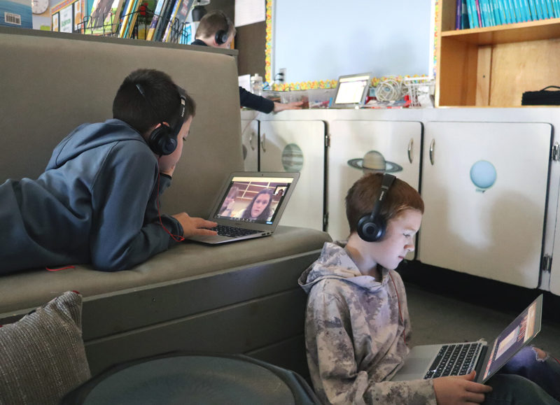 Fifth graders Everett Oakes (left) and Kayden GaNun speak with their book buddies, elementary education students from the University of Maine at Farmington, over Zoom on Wednesday, Nov. 29. Oakes said this is the second year he is participating in this program. (Piper Pavelich photo)