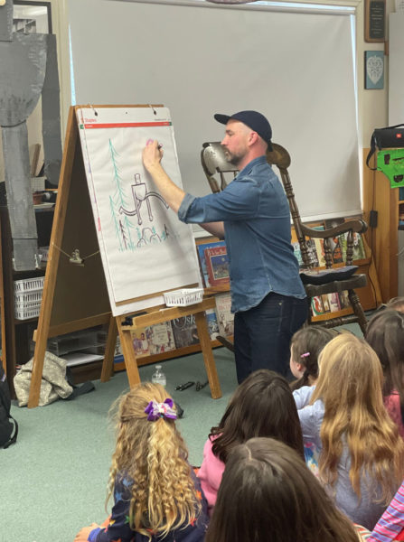 New York Times bestselling author Peter Brown personalizes a sketch for Center for Teaching and Learning students during a visit to the school on Monday, Dec. 4. (Photo courtesy Center for Teaching and Learning)
