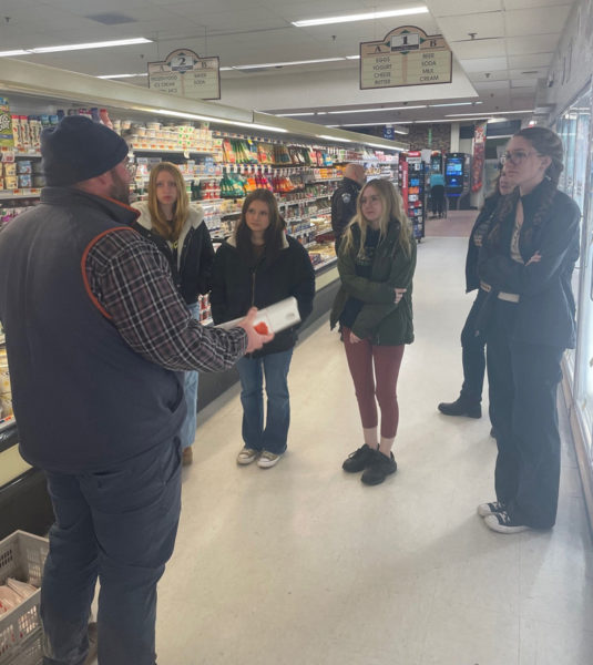 Lincoln Academy students inside Main Street Grocery in Damariscotta take part in Project Sticker Shock on Wednesday, Dec. 6. (Photo courtesy Jake Abbott)