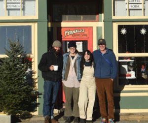 From left: Jon Merry, Ramsea Lucas, Alexandra Welch, and Derek Degeer stand outside S. Fernald's Country Store in Damariscotta, the business they plan to buy together after 18 months on the market with the help of a crowdfunding campaign. The four locals were connected by "kismet, fate, and destiny" to make the purchase happen, they said. (Elizabeth Walztoni photo)