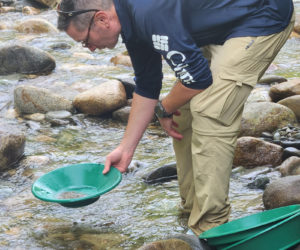 Navy veteran Chris Nadeau, of Wells, pans for gold in a western Maine stream during an Operation Reboot gold rush mission last August. (Photo courtesy Mitch Mitchell)