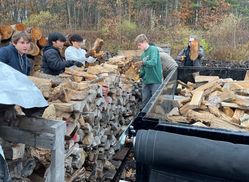 Lincoln Academy students load a trailer with firewood for delivery in November 2023. Heating assistance is just one part of the Community Housing Improvement Projects year-round effort to keep people safe, warm, and dry in their homes. (Photo courtesy Community Housing Improvement Project)