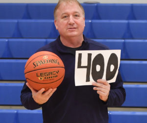Nick DePatsy celebrates his 400th coaching win with the game ball and a fan's sign. (Mic LeBel photo)