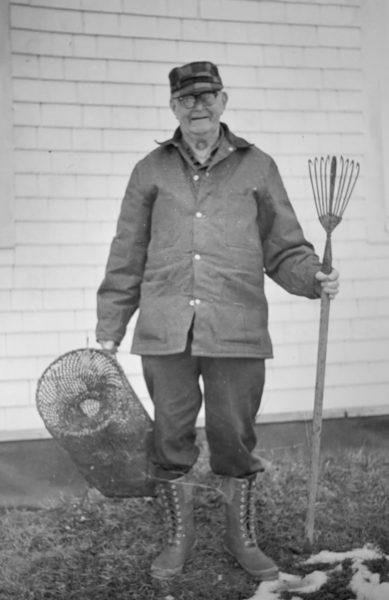 Harold Coombs of Belvedere Road holds the five-pronged eel spear used in 1879 by his uncle, William Coombs. Also shown is an eel trap formerly used during the summer by Wilbert J. Plummer, father of Mrs. Harold Coombs. (Photo courtesy Nobleboro Historical Society)