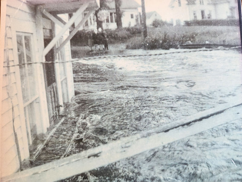 Bridge unpassable and Leo Munroe's house under water in 1951. (Photo courtesy Lori Crook)