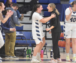 Former Lincoln Academy star Maddy York celebrates the Seawolves' dramatic overtime win with head coach Katie Stannard and teammates. (Mic LeBel photo)