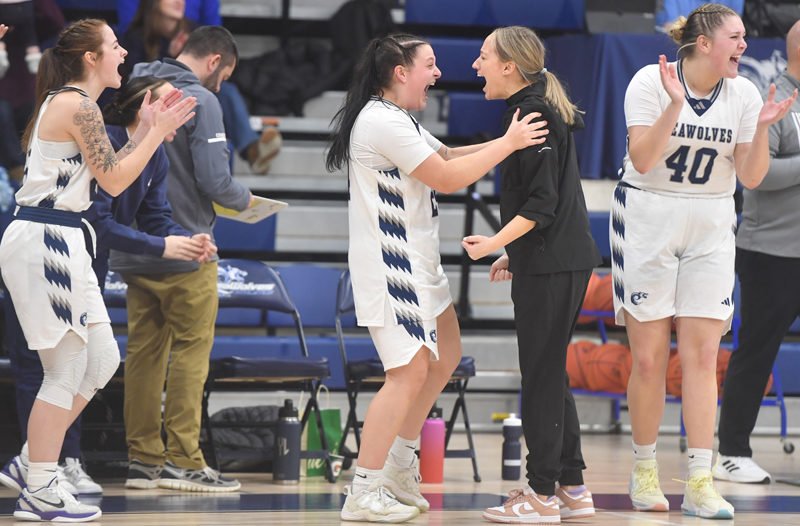 Former Lincoln Academy star Maddy York celebrates the Seawolves' dramatic overtime win with head coach Katie Stannard and teammates. (Mic LeBel photo)