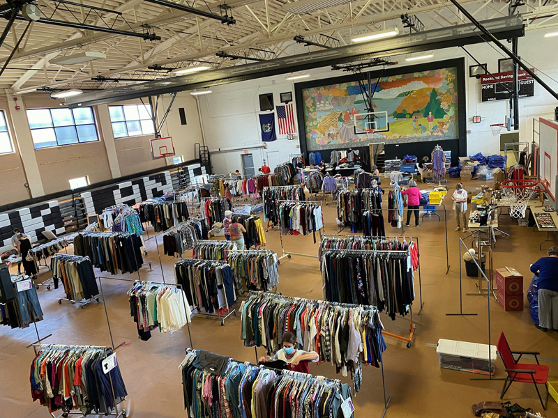 Shop for Hope volunteers ready the space for New Hope Midcoast's annual fundraising sale. (Photo courtesy New Hope Midcoast)