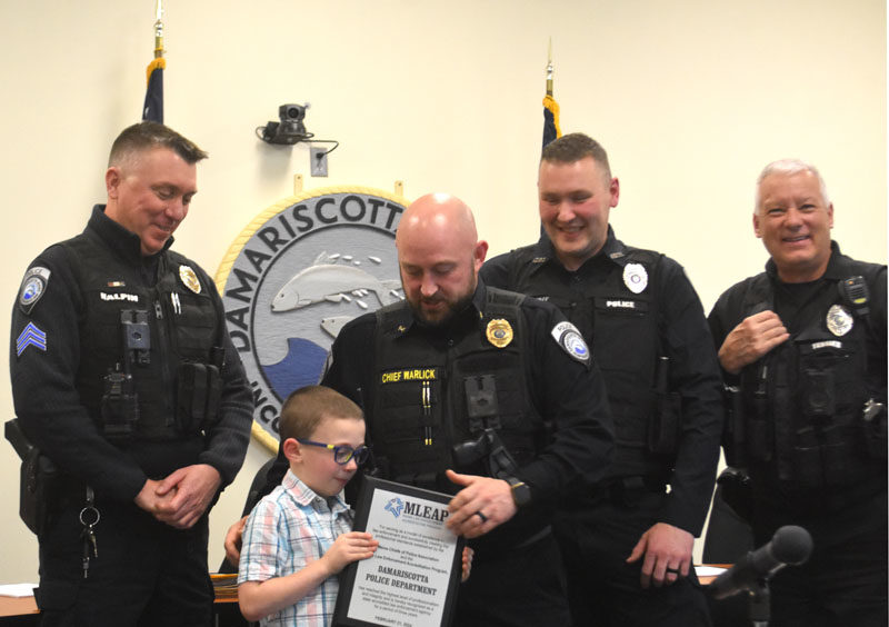 From left: Damariscotta Police Department Sgt. Erick Halpin, Hayden Warlick, Chief Jason Warlick, Officer Tyson Fait, and Officer Phil Tessier receive a plaque for the department's new state accreditation on Wednesday, Feb. 21. Damariscotta is now one of 27 agencies in the state accredited by the Maine Law Enforcement Accreditation Program, a process that involves adopting best practice standards and policies developed by the program. (Elizabeth Walztoni photo)