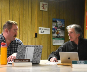 Edgecomb Select Board members Michael Maxim (left) and Mike Smith confer during a board meeting on Tuesday, Feb. 20. The town may become eligible for federal grants from the Land and Water Conservation Fund after 20 years of noncompliance if it determines it can use part of a tax-acquired property to meet equivalency requirements. (Elizabeth Walztoni photo)