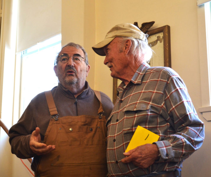 Although they disagreed on the merits of the special town meeting warrant article, Westport Island residents Mario DePietro (left) and Bill Hopkins discuss the issue in a neighborly fashion after casting their ballots Saturday, Feb. 24. (Charlotte Boynton photo)