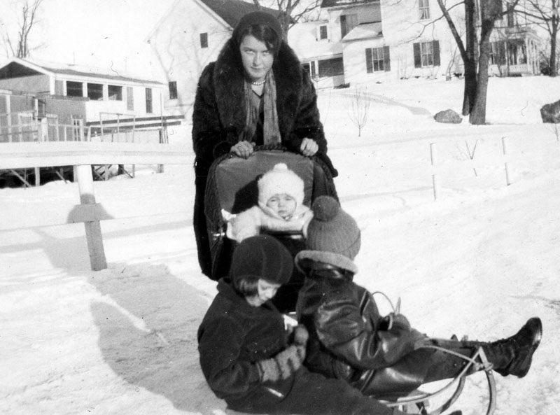 Marion Emily Hitchcock stands behind 2-year-old Marjorie A. Cooper and 5-year-old Llewellyn Cooper and playmate Carolyn Denny on a sled at Round Top Farms during the winter of 1932. Marion Hitchcock was babysitting the children that day. (Photo courtesy Calvin Dodge collection)