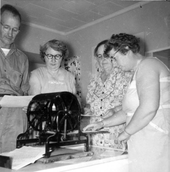 From left: Winfield Cooper, Kathleen Cooper, Mattie Hitchcock, and Beatrice Barstow print flyers on a mimeograph copier in 1945 in the Cooper kitchen on Round Top. The Coopers bought the former Knowlton Farm in 1943. We have many copies of the auction flyers and photos of Winfields Cooper auctions. (Photo courtesy Calvin Dodge collection)