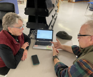 Brett Cole (right), a Midcoast Adult & Community Education instructor, helps a community member with a laptop issue at the RSU 40 Community Tech Night in November 2023. (Courtesy photo)