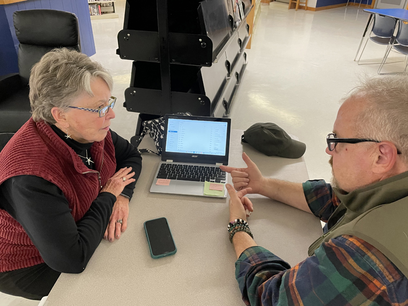 Brett Cole (right), a Midcoast Adult & Community Education instructor, helps a community member with a laptop issue at the RSU 40 Community Tech Night in November 2023. (Courtesy photo)